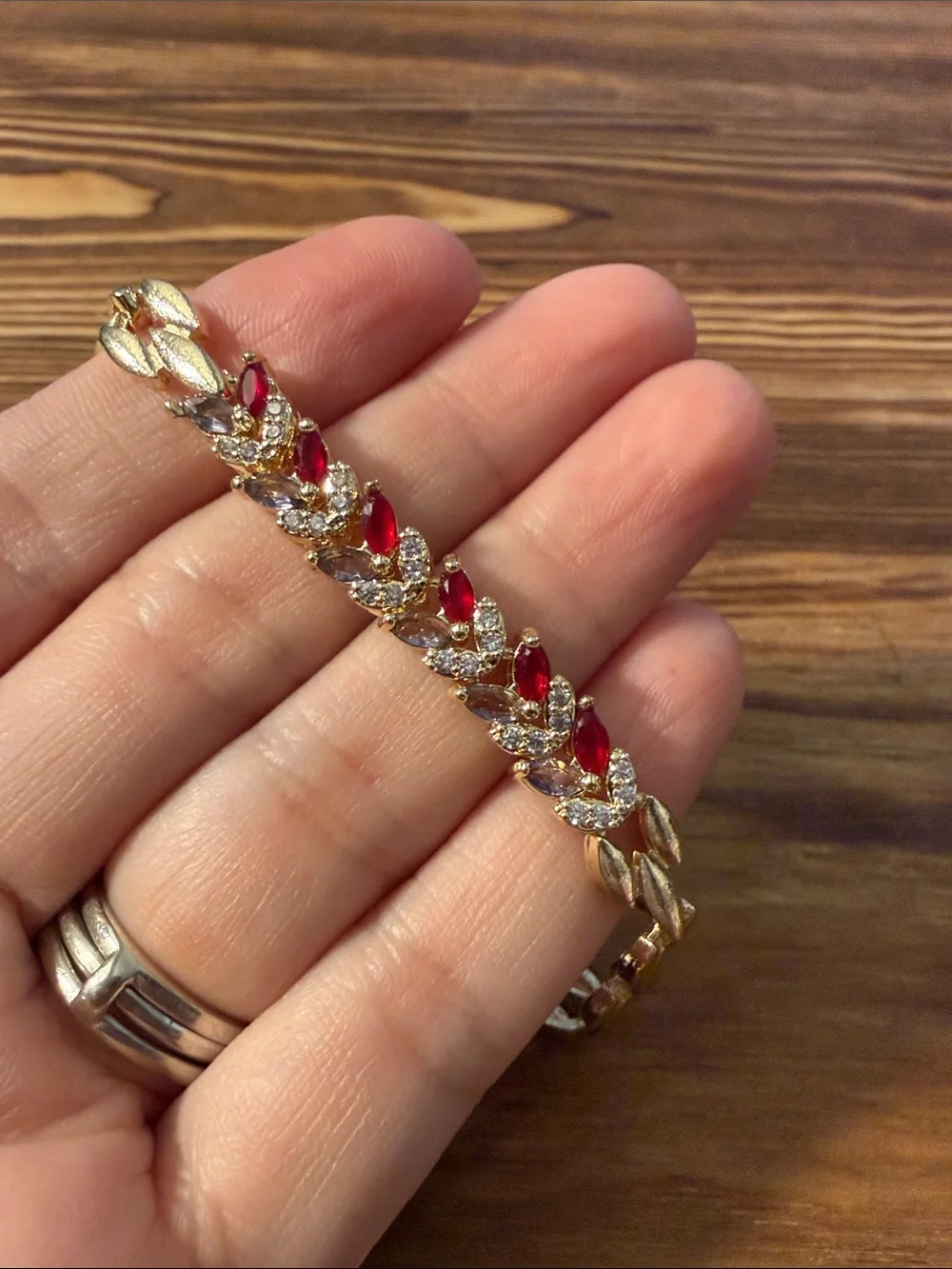 Gold-Tone Bracelet with Red Gem Leaf Accents